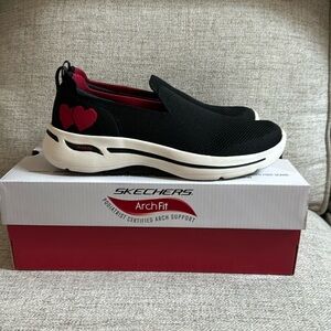 Skechers Arch-fit slip on black sneakers with red hearts